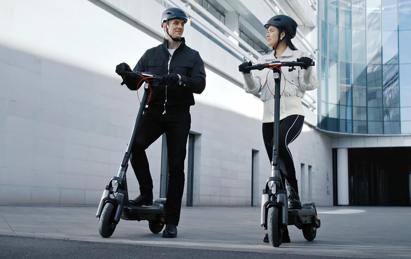 Two riders on Segway Ninebot Max G3 electric scooters in a city
