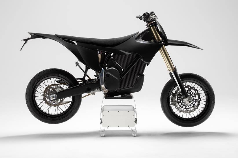 Studio side profile of the all-black Stark Varg SM Sköll electric supermoto on a stand